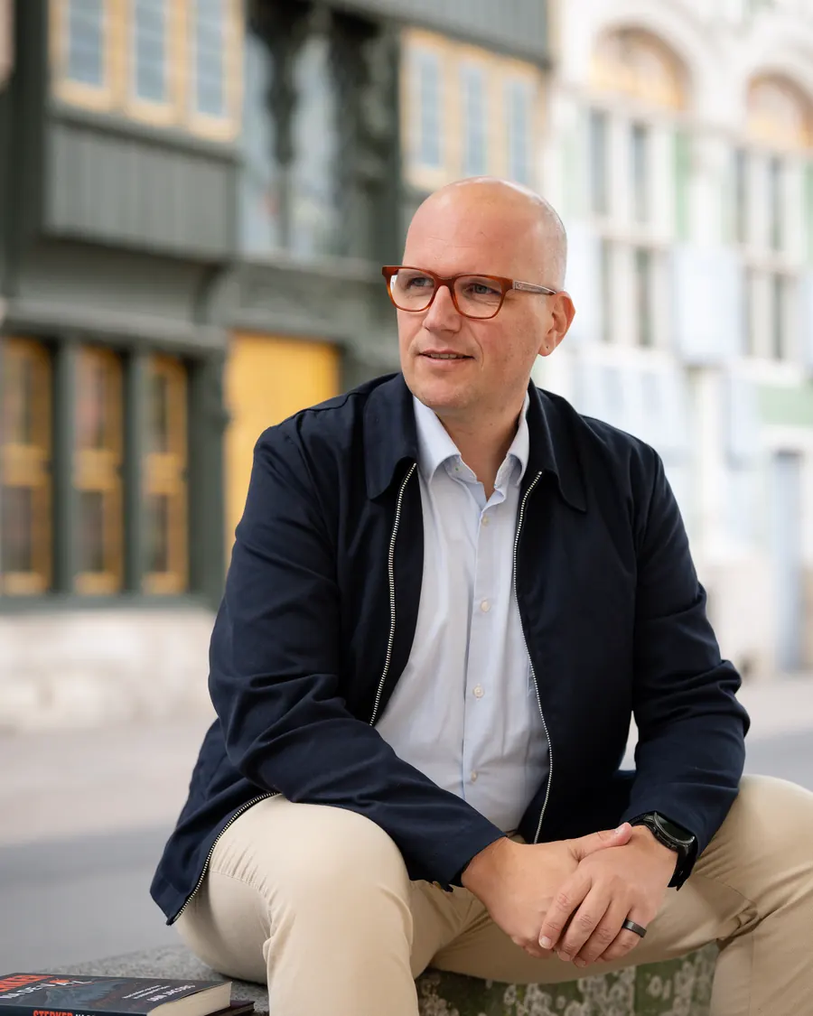 Jan Jacobs zit op een rand in Mechelen en kijkt opzij